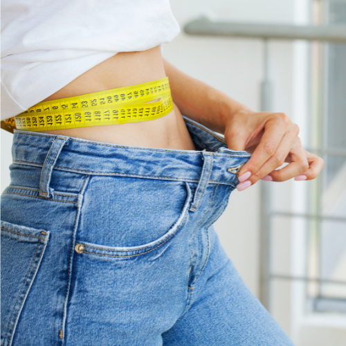 woman measuring waist for liquid lipo